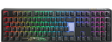 A colorful backlit mechanical gaming keyboard with vibrant rainbow LED lights, featuring a Ducky One 3 - Classic Black / White Nordic - Fullsize - Cherry Red logo on the space bar and a dark gray frame. The keys are laid out in a typical QWERTY configuration.