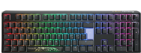 A colorful backlit Ducky One 3 - Classic Black Nordic - Fullsize - Cherry Silent Red mechanical gaming keyboard with keys illuminated in a rainbow gradient, featuring a black body and a visible Ducky logo at the bottom center.